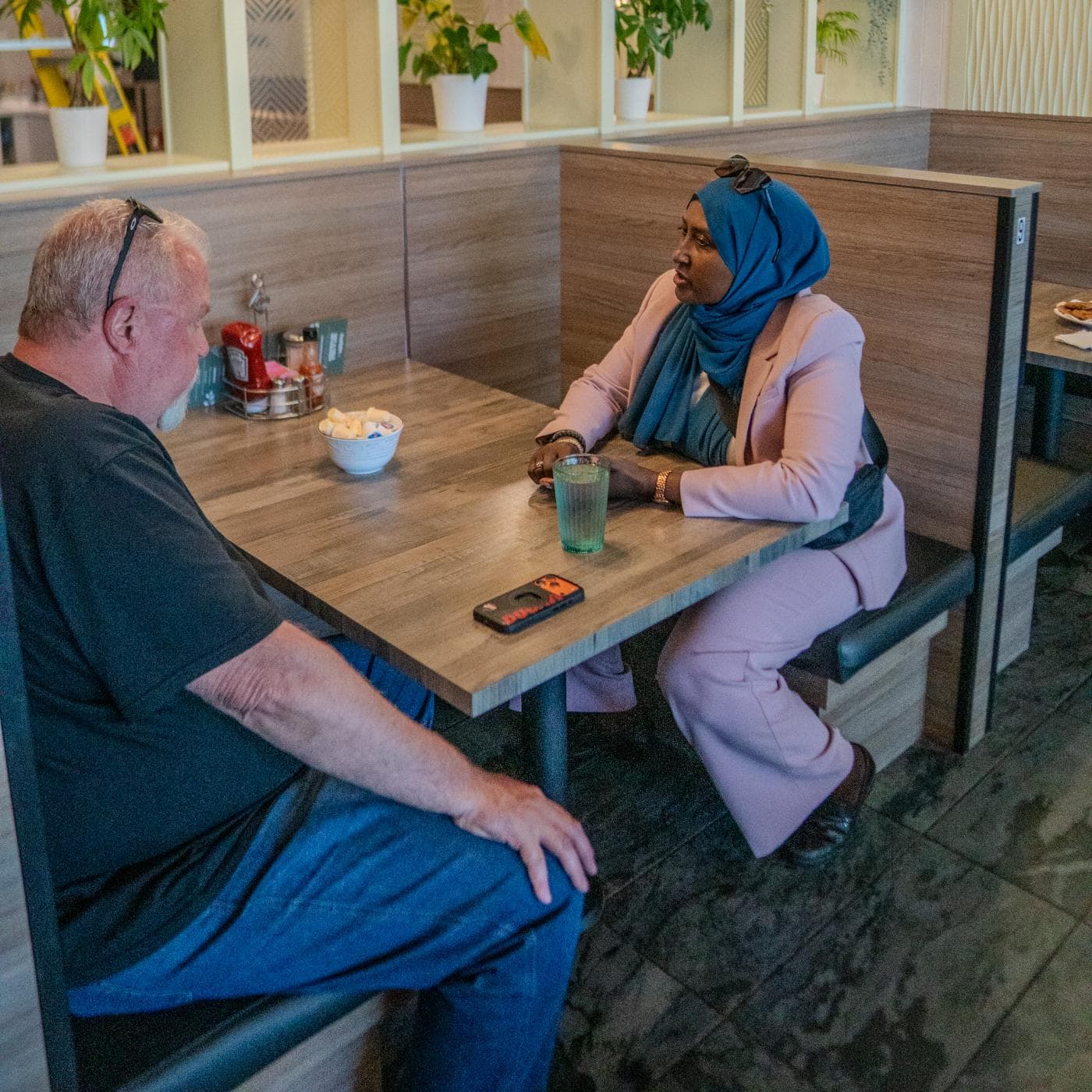 Osob Adus in conversation with a Ward 6 resident at the June 6 meet-and-greet.